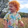 Stetson is registered to the contest to win money with this photo: child, toddler, red_hair, curly_hair, pineapple_shirt, short_sleeve, field, tall_grass, outdoors, portrait, smile, profile, nature, trees, sky, sunny, candid, hand, exploring, happy
