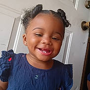 Amaiya Young joined the competition — help win amazing prizes! toddler, child, smile, happy, face, hair, dress, blue_dress, curly_hair, indoor, door, doorknob, earrings, person, portrait, cute, young_child, skin, tongue, fashion