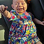 Emma joined the competition — help win amazing prizes! baby, infant, smiling, dimple, floral_dress, colorful, car_seat, vehicle_interior, sunlight, shadow, hand_reaching, portrait, cute, happy, skin, fabric, seat_belt_clip, playful, close_up, casual