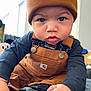 baby, child, face, beanie, carhartt, overalls, sneaker, jordan, hand, indoor, curious, blue_eyes, clothing, portrait, cute, infant, black_shoe, soft_light, closeup, warm_colors