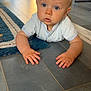 Maxime participe au concours pour gagner de l'argent avec cette photo : baby, child, indoor, floor, blue_eyes, curious, hands, shirt, tile_floor, rug, toy, home, crawling, person, young, infant, portrait, bright, looking, casual