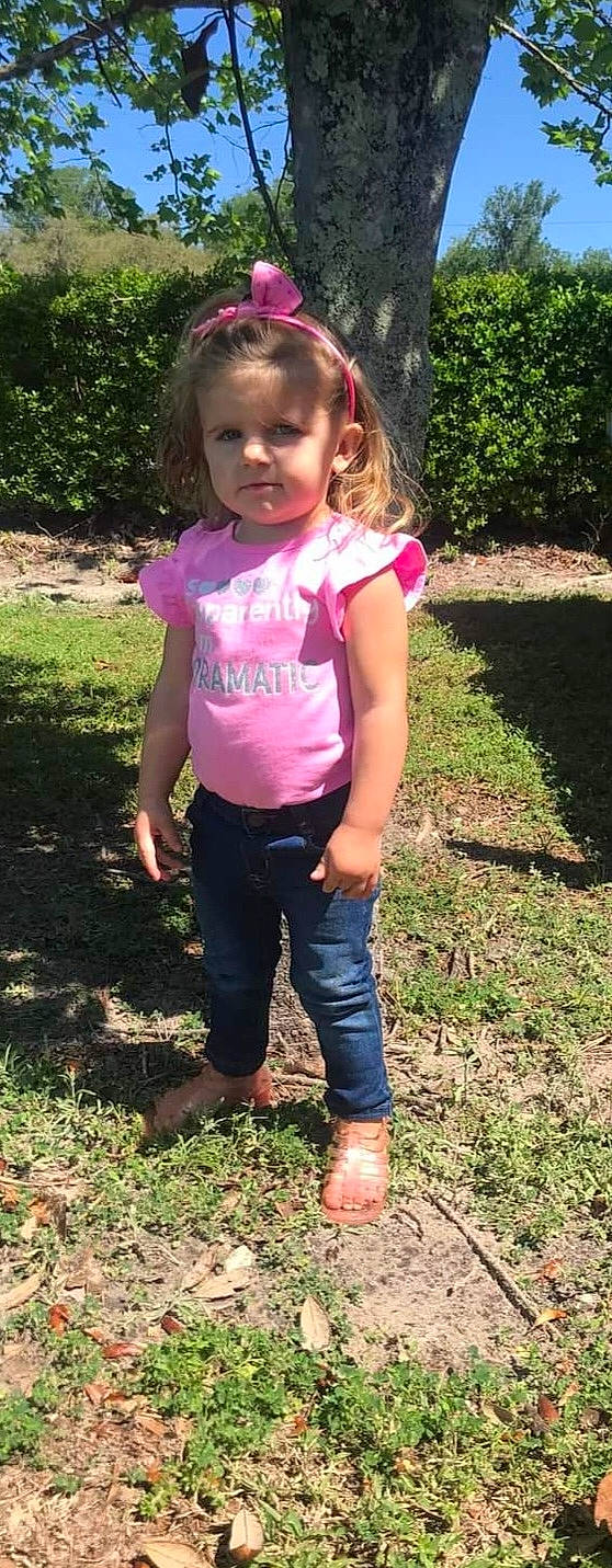 Hannah Saia joined the competition — help win amazing prizes! active_pants, baby_toddler_clothing, fun, gesture, grass, hair, happy, magenta, people_in_nature, person, pink, plant, sleeve, soil, sweatpant, t_shirt, thigh, toddler, tree, waist