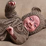 Jackson is registered to the contest to win money with this photo: baby, blanket, bodypart, bonnet, cap, clothing, face, finger, hand, happy, hat, head, hood, knitwear, newborn, person, photography, portrait, smile, sweater
