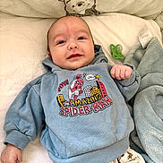 Owenn a rejoint le concours — aidez-le/la à gagner de superbes lots ! baby, smiling, blue_hoodie, spiderman, comic_print, blanket, winnie_the_pooh, pacifier, bed, pajamas, infant, cute, child, clothing, soft, lying_down, indoors, portrait, face, hand