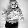 Owenn participe au concours pour gagner de l'argent avec cette photo : baby, infant, smile, shirt, pants, socks, lying_down, portrait, black_and_white, cute, child, young, happy, face, clothing, person, indoors, soft_surface, casual, baby_fashion