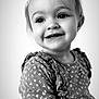 child, toddler, portrait, black_and_white, smiling, happy, face, eyes, clothing, dress, flower_pattern, young, cute, person, head, hair, indoors, expression, baby, closeup