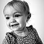 child, toddler, portrait, black_and_white, smiling, happy, face, eyes, dress, pattern, ruffles, young_child, cute, innocence, joyful, clothing, baby, person, studio, closeup