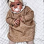 baby, blanket, bonnet, cap, clothing, dress, face, happy, hat, head, knitwear, newborn, pants, person, photography, portrait, sitting, sleeve, smile, sweater