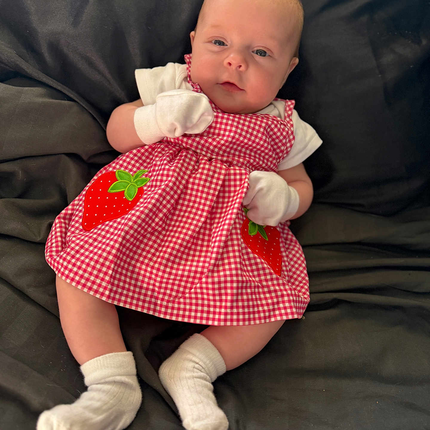 Tullulah joined the competition — help win amazing prizes! baby, bodypart, clothing, couch, dress, face, finger, footwear, furniture, glove, head, hosiery, newborn, person, photography, portrait, shoe, sitting, sock, toy