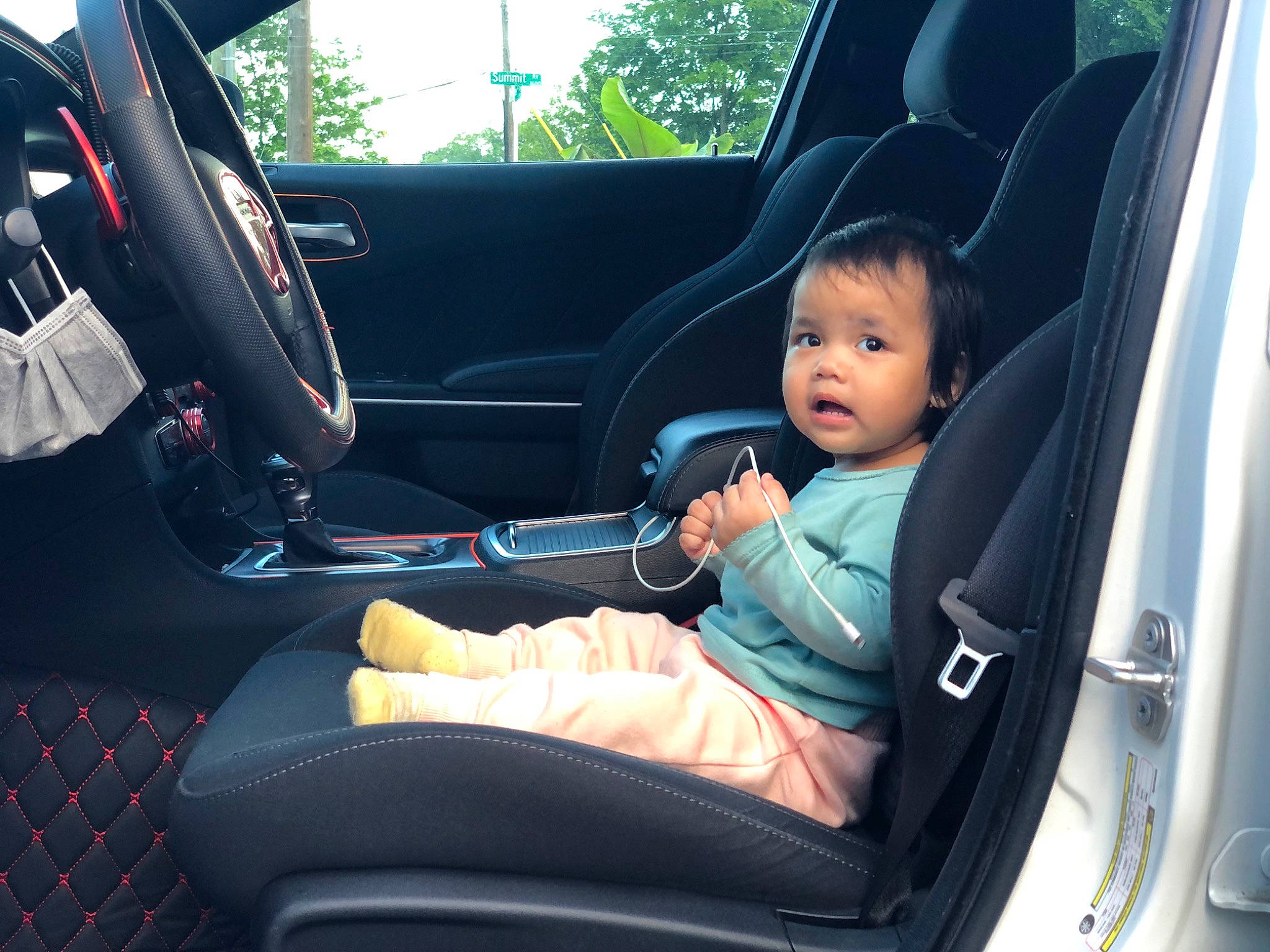 Alina is registered to the contest to win money with this photo: auto_part, automotive_design, automotive_exterior, car, car_seat, car_seat_cover, comfort, head_restraint, land_vehicle, mode_of_transport, motor_vehicle, person, personal_luxury_car, plant, seat_belt, steering_part, steering_wheel, toddler, vehicle, vehicle_door