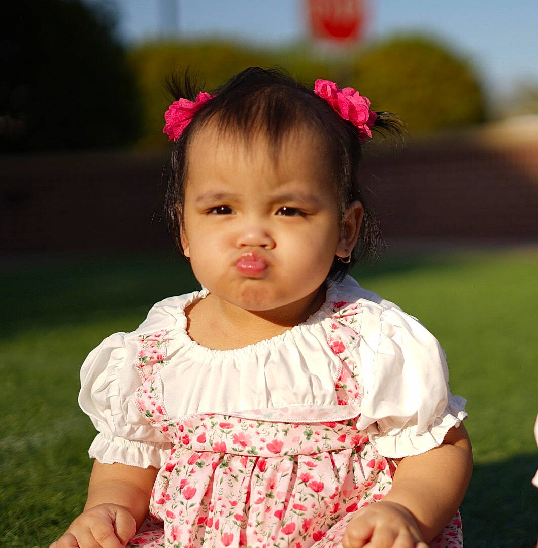 Amina is registered to the contest to win money with this photo: baby_toddler_clothing, cheek, child, chin, dress, eye, eyelash, face, flash_photography, grass, happy, head, iris, lip, neck, people_in_nature, person, pink, skin, sleeve