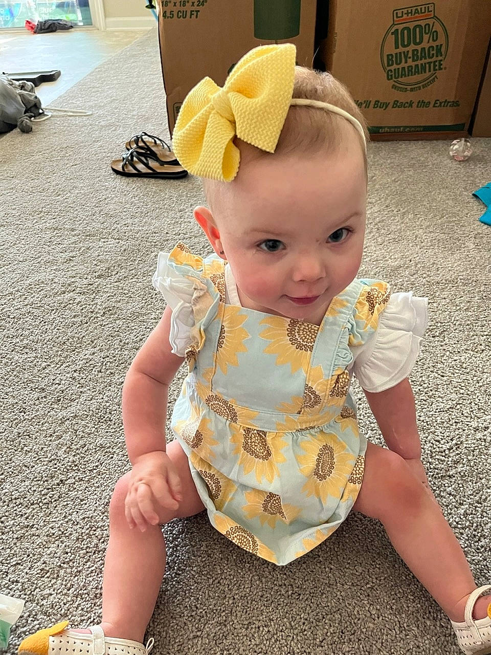 Mckenzie Rain is registered to the contest to win money with this photo: baby, baby_toddler_clothing, box, child, costume, fashion_accessory, flooring, foot, fun, happy, hat, human_leg, lap, pattern, person, shipping_box, sitting, toddler