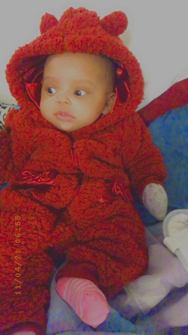 Isla is registered to the contest to win money with this photo: baby, baby_toddler_clothing, cap, cheek, child, comfort, eye, head, headgear, iris, jacket, lip, nose, organ, outerwear, person, red, skin, sleeve, textile