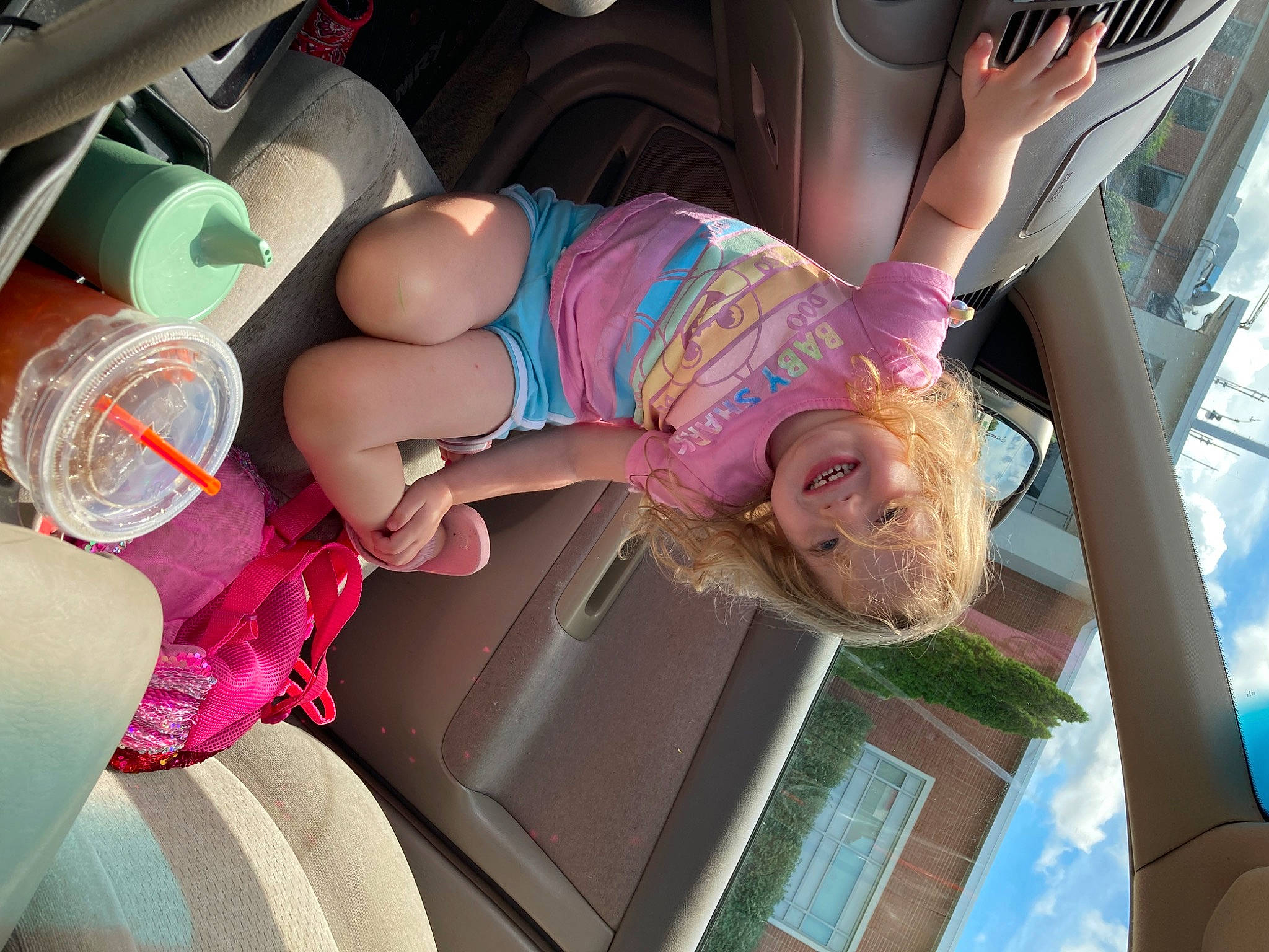Kenzlee joined the competition — help win amazing prizes! automotive_exterior, car, car_seat, car_seat_cover, eyewear, family_car, finger, fun, glasses, happy, human_leg, joy, leisure, motor_vehicle, person, pink, smile, sunglasses, thigh, toddler