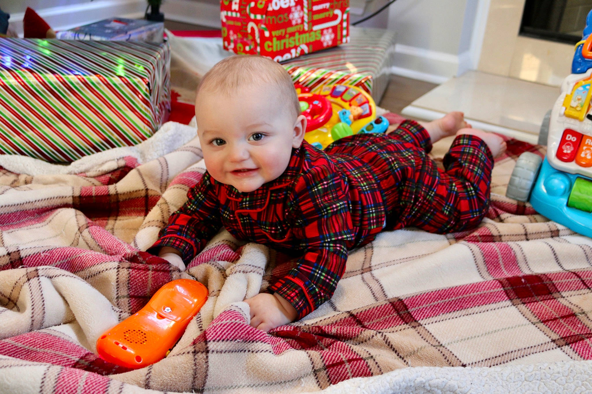 Cole is registered to the contest to win money with this photo: baby, child, christmas_eve, joy, person, plaid, play, room, sitting, toddler