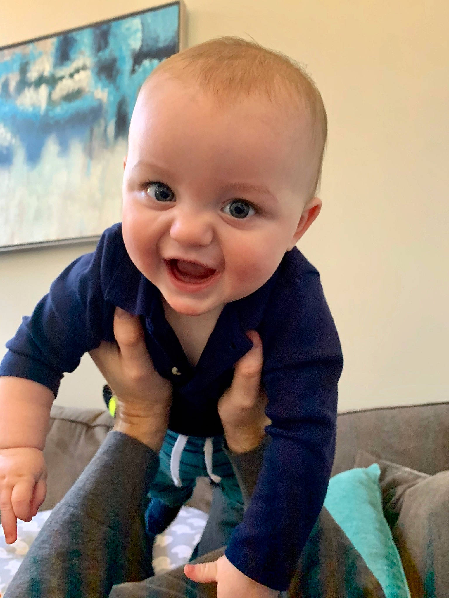 Cole joined the competition — help win amazing prizes! baby, blue, cheek, child, eye, face, facial_expression, finger, head, joy, leg, nose, person, sitting, skin, sleeve, smile, t_shirt, toddler, tummy_time