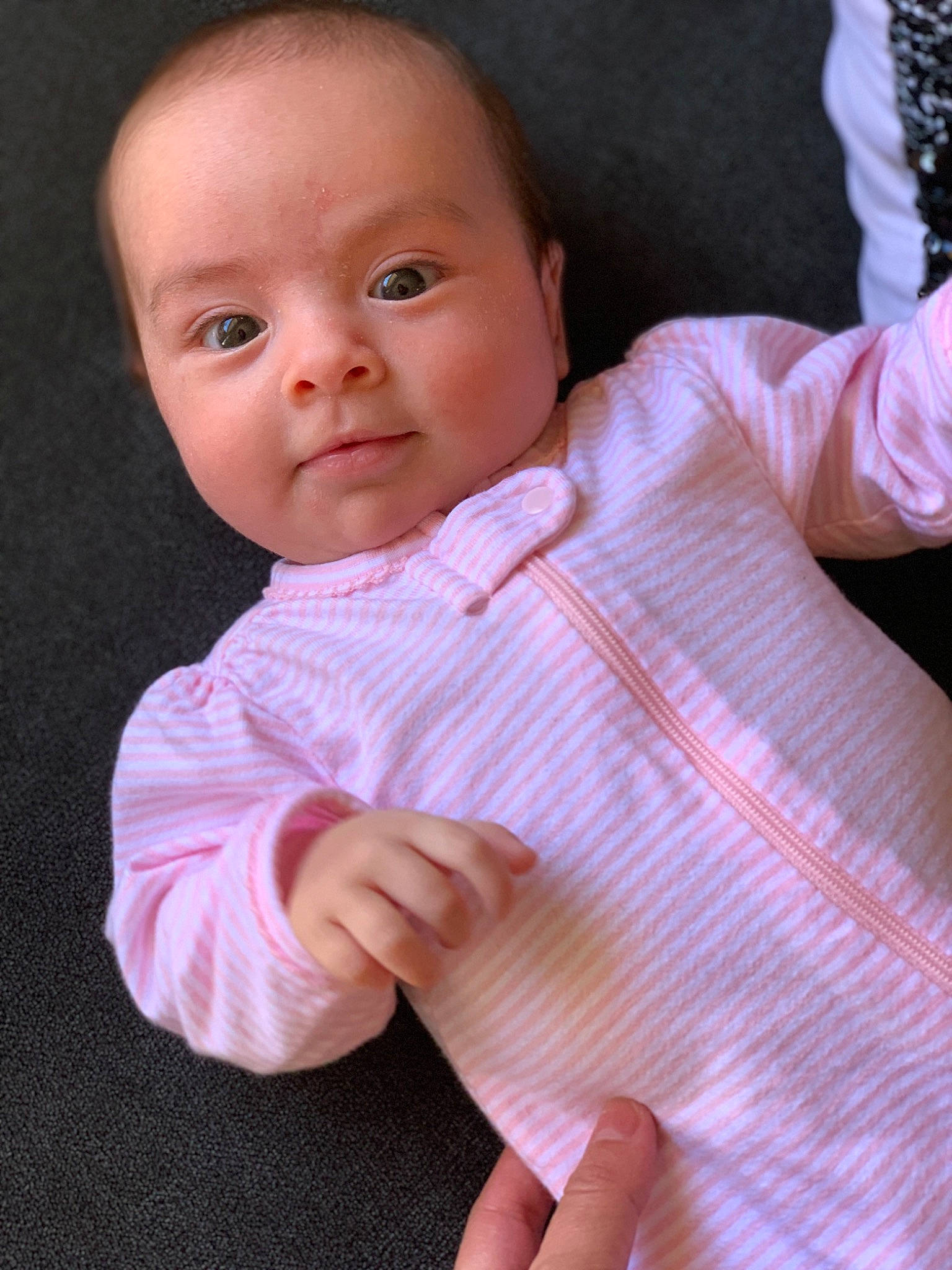 Ellyana is registered to the contest to win money with this photo: arm, baby, baby_toddler_clothing, cheek, child, face, finger, gesture, hand, head, lip, person, pink, skin, sleeve, smile, thumb, toddler