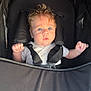 Illyano participe au concours pour gagner de l'argent avec cette photo : baby, child, stroller, blue_eyes, hair, straps, white_clothing, infant, cute, face, hands, sitting, seat, closeup, portrait, young_child, safety_harness, curly_hair, indoors, expression