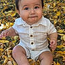 autumn, baby, child, dark_hair, daylight, face, fall, golden_leaves, grass, infant, leaves, nature, outdoor, photography, portrait, shirt, shorts, sitting, smiling, white_outfit