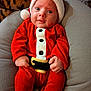 baby, bright_eyes, child, christmas, cozy, cushion, cute, face, festive, hands, hat, holiday, indoor, infant, person, portrait, red_clothing, santa_outfit, smiling, warm