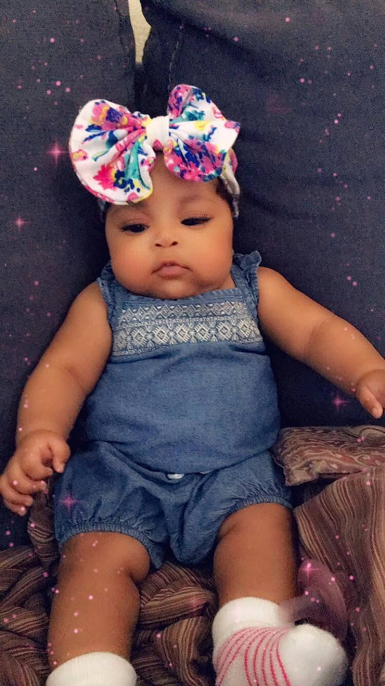 Anyla is registered to the contest to win money with this photo: baby, baby_toddler_clothing, bonnet, cap, child, clothing, fashion_accessory, fun, hair_accessory, hat, headgear, headwear, person, pink, play, sitting, smile, toddler