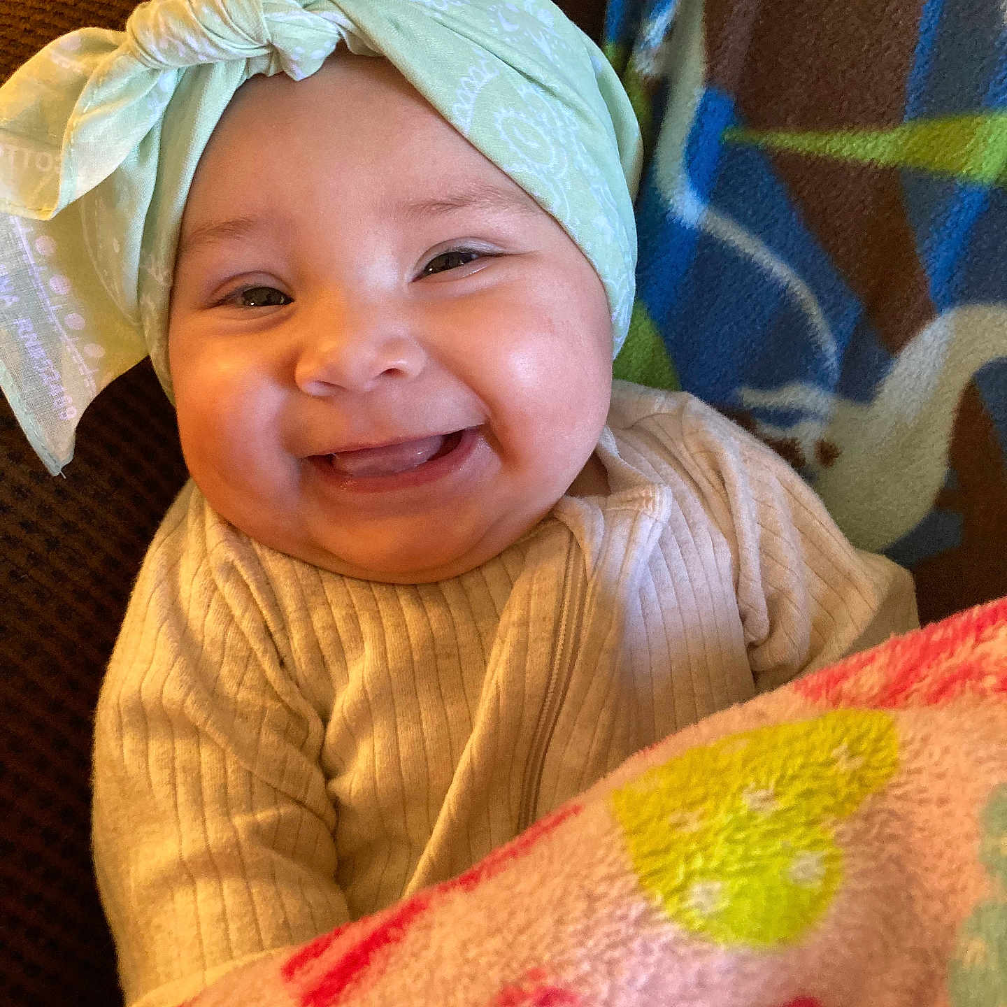 Shiloh is registered to the contest to win money with this photo: accessories, architecture, baby, babylaughing, bed, bedroom, blanket, bodypart, bonnet, building, cap, clothing, coat, costume, couch, cushion, dress, earring, face, furniture