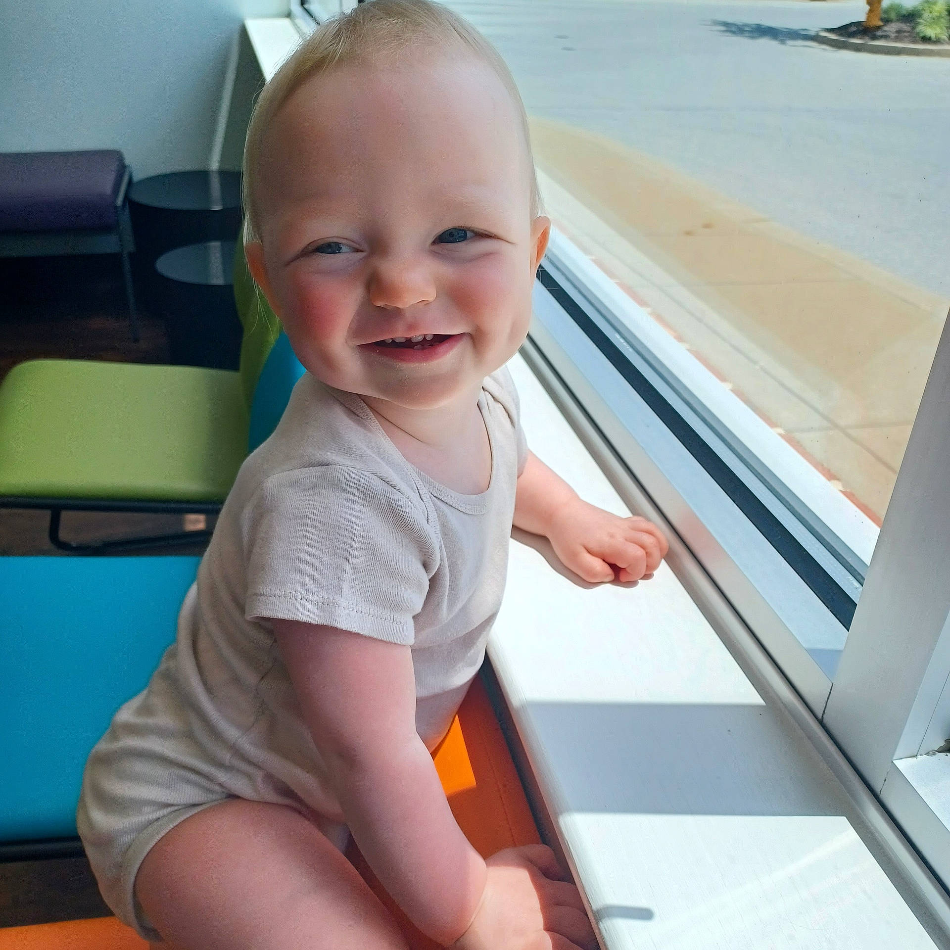 Travis is registered to the contest to win money with this photo: baby, babylaughing, bodypart, chair, clothing, couch, face, furniture, happy, head, laughing, mouth, person, photography, portrait, sitting, smile, t_shirt, window, windowsill