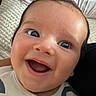 Eden joined the competition — help win amazing prizes! baby, infant, child, smiling, laughing, portrait, face, eyes, happy, indoor, bed, pillow, blanket, clothing, onesie, close_up, lying_down, cozy, photography, adorable