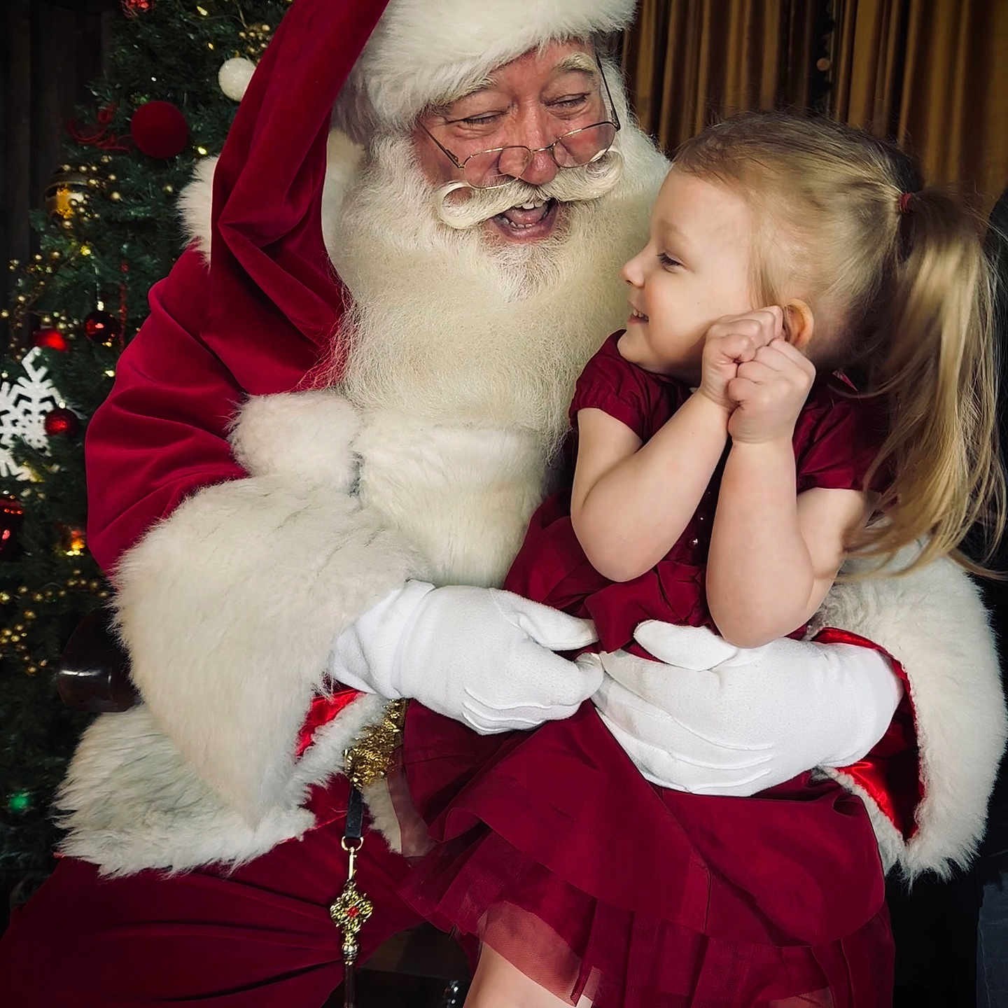 Mae is registered to the contest to win money with this photo: celebration, child, christmas_lights, christmas_tree, decorations, family, festive, glasses, gloves, happy, holiday, indoor, joy, portrait, red_dress, santa_claus, seasonal, smiling, toddler, white_beard
