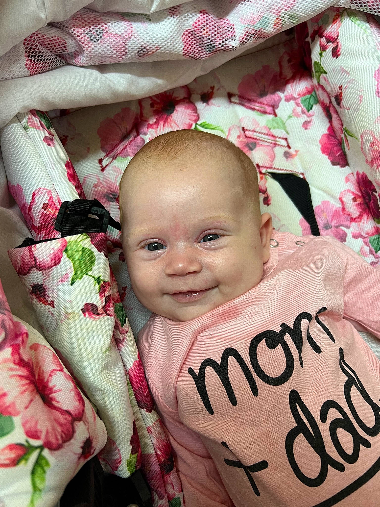 Maddy participe au concours pour gagner de l'argent avec cette photo : baby, baby_toddler_clothing, carmine, cheek, child, chin, event, face, happy, head, linens, magenta, pattern, person, petal, pink, skin, sleeve, smile, textile