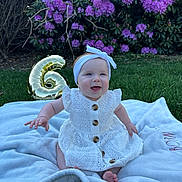 Harper is registered to the contest to win money with this photo: baby, girl, smiling, white_dress, headband, blanket, grass, balloon, number_6, purple_flowers, outdoor, garden, celebration, happy, sitting, cute, portrait, daylight, nature, child