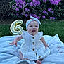 baby, girl, smiling, white_dress, headband, blanket, grass, balloon, number_6, purple_flowers, outdoor, garden, celebration, happy, sitting, cute, portrait, daylight, nature, child