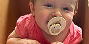 Harper joined the competition — help win amazing prizes! baby, pacifier, box, diapers, child, cute, hands, pink_clothing, smile, face, infant, indoor, cardboard, playful, young_child, portrait, holding, looking_up, closeup, light