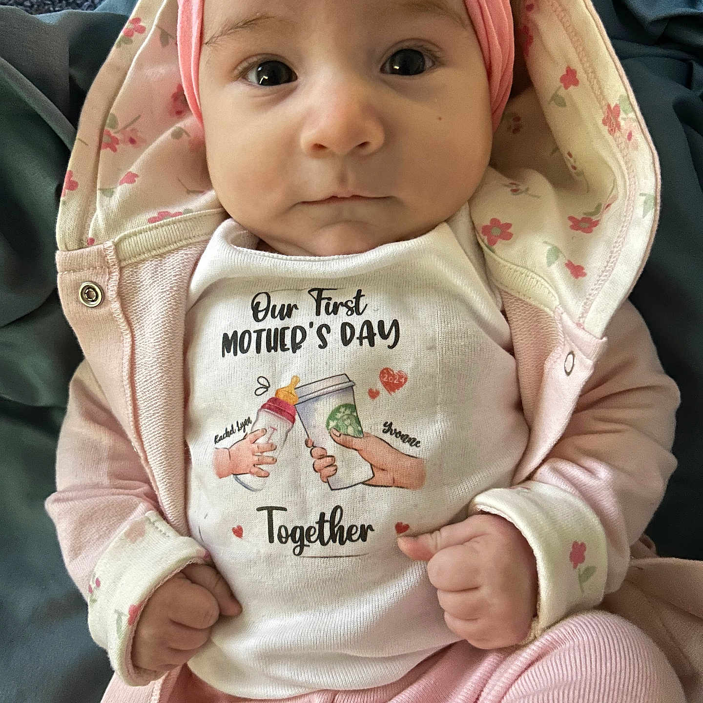 Rachel is registered to the contest to win money with this photo: baby, bodypart, bonnet, clothing, coat, face, finger, hand, hat, head, hood, hoodie, jacket, knitwear, pants, person, photography, portrait, sweater, sweatshirt