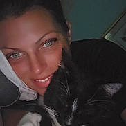 Ali is registered to the contest to win money with this photo: animal, black_and_white_cat, cat, close_up, cozy, dark_background, face, feline, friendship, happy, human, indoor, person, pet, portrait, relaxed, sleepy, smiling, snuggling, whiskers