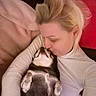 Elvira participe au concours pour gagner de l'argent avec cette photo : woman, dog, cuddle, kiss, indoor, blonde_hair, white_turtleneck, relaxation, pet, love, affection, close_up, lying_down, comfort, casual, resting, companion, domestic, bond, warmth