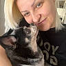 Elvira participe au concours pour gagner de l'argent avec cette photo : woman, dog, pet, indoor, smile, blonde_hair, affection, closeup, portrait, casual, black_dog, white_markings, human, animal, love, holding, face, light, happy, cute