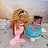 Malani is registered to the contest to win money with this photo: baby, child, mermaid_costume, pink, cake, birthday_cake, sprinkles, pearl_necklace, chair, beach, sand, shell_backdrop, headband, celebration, blue_cake, ocean_theme, decorations, portrait, cute, smile