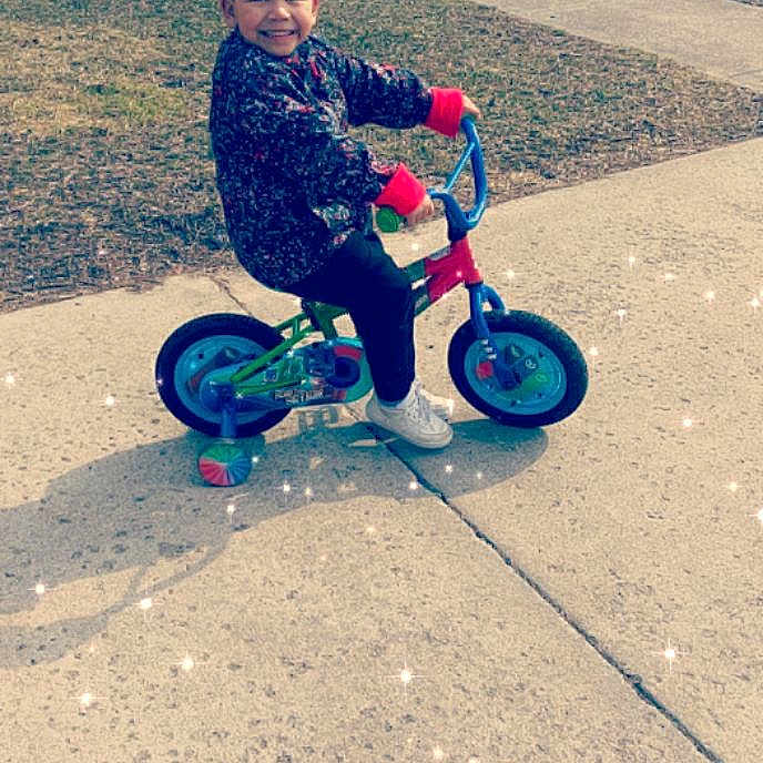 Kymani joined the competition — help win amazing prizes! auto_part, automotive_wheel_system, bicycle_accessory, child, cycling, fun, joy, mode_of_transport, person, play, recreation, toddler, training_wheels, tricycle, vehicle, wheel