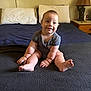 baby, bed, blanket, blue_sheet, child, cute, face, feet, hands, happy, indoors, infant, lamp, pillows, plump, sitting, skin, smiling, striped_clothing, wooden_nightstand
