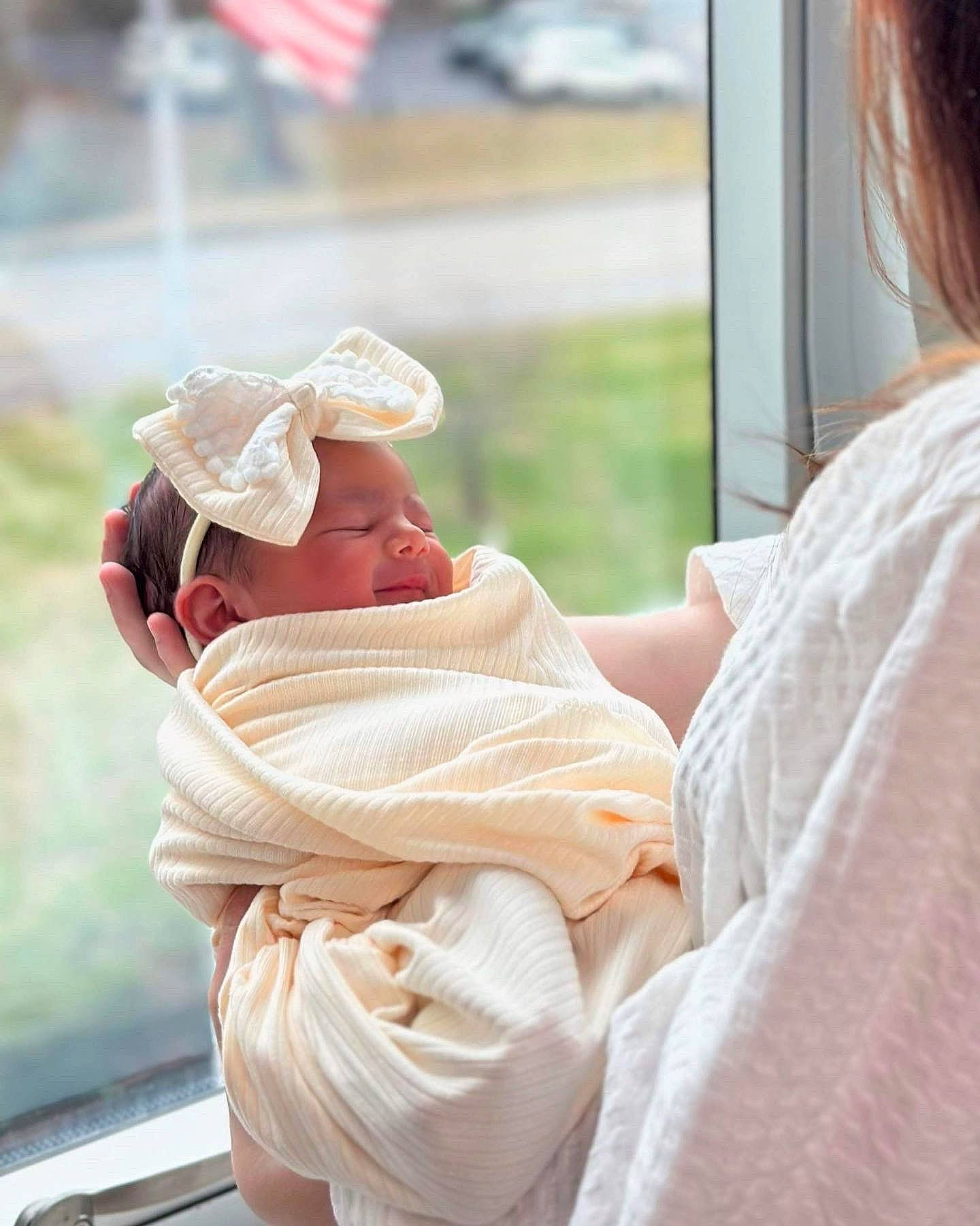 Octavia is registered to the contest to win money with this photo: baby, cap, child, comfort, flag, flag_day_usa, flag_of_the_united_states, fun, grass, happy, hat, headwear, hug, leisure, linens, person, room, shoulder, sitting, toddler