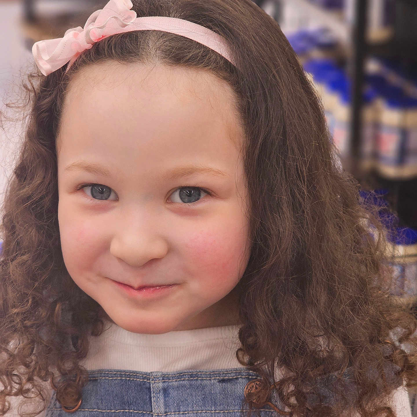 Mykayla is registered to the contest to win money with this photo: accessories, bodypart, child, clothing, face, female, finger, food, girl, hand, happy, head, headband, pants, person, photography, portrait, shelf, smile, sweets