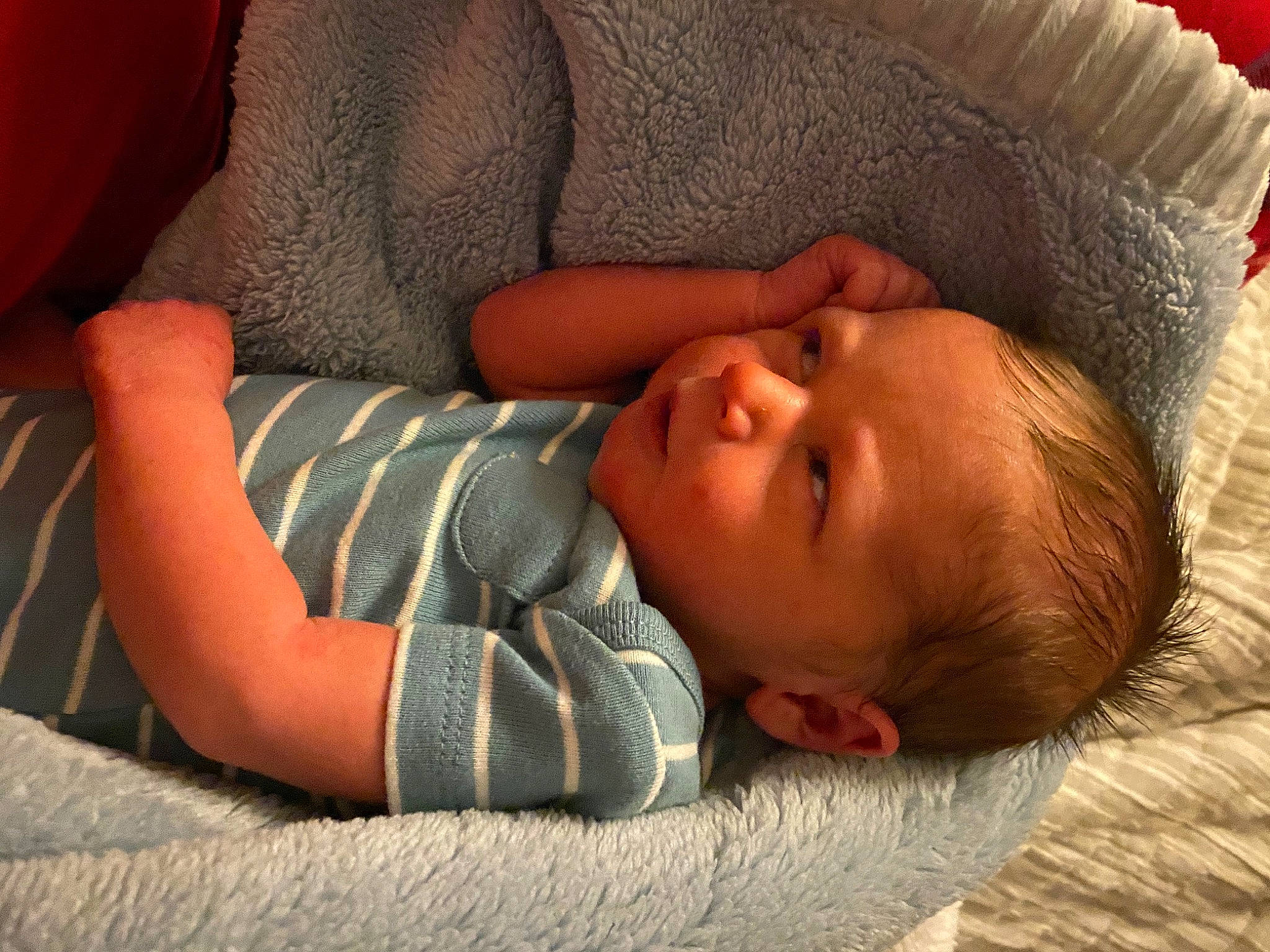 Judson is registered to the contest to win money with this photo: baby, baby_toddler_clothing, cheek, child, chin, comfort, eye, facial_expression, grass, hand, head, human_body, linens, lip, mouth, nose, person, skin, toddler, vertebrate