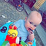 Ren joined the competition — help win amazing prizes! baby, child, walker, toy, outdoor, stroller, curious, blue_shirt, face, chewing, playful, ground, trees, sidewalk, seat, person, young_child, colorful, plastic, nature