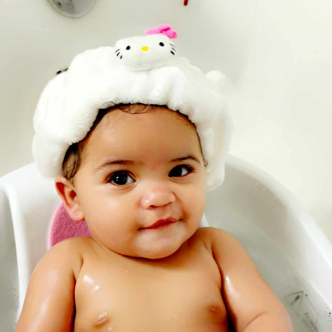 Tresure is registered to the contest to win money with this photo: baby, bath, bathtub, child, childhood, cute, hat, hello_kitty, indoors, infant, person, playful, plush, rubber_duck, sitting, skin, smile, toddler, toy, water