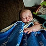 baby, sleeping, blanket, couch, pillow, indoor, child, infant, comfort, rest, soft, cozy, furniture, relaxation, home, person, peaceful, cute, face, hand