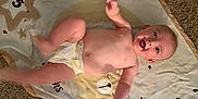 Hudson is registered to the contest to win money with this photo: baby, diaper, blanket, numbers, stars, carpet, smile, face, child, infant, happy, playful, lying_down, kicking, cute, indoors, young, skin, head, person