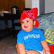 Jesreen joined the competition — help win amazing prizes! baby, child, infant, portrait, smiling, tongue_out, bandana, red_headwear, blue_shirt, floral_pattern, sitting, armchair, indoor, home, face, eyes, cheeks, happy, casual_clothing, photography