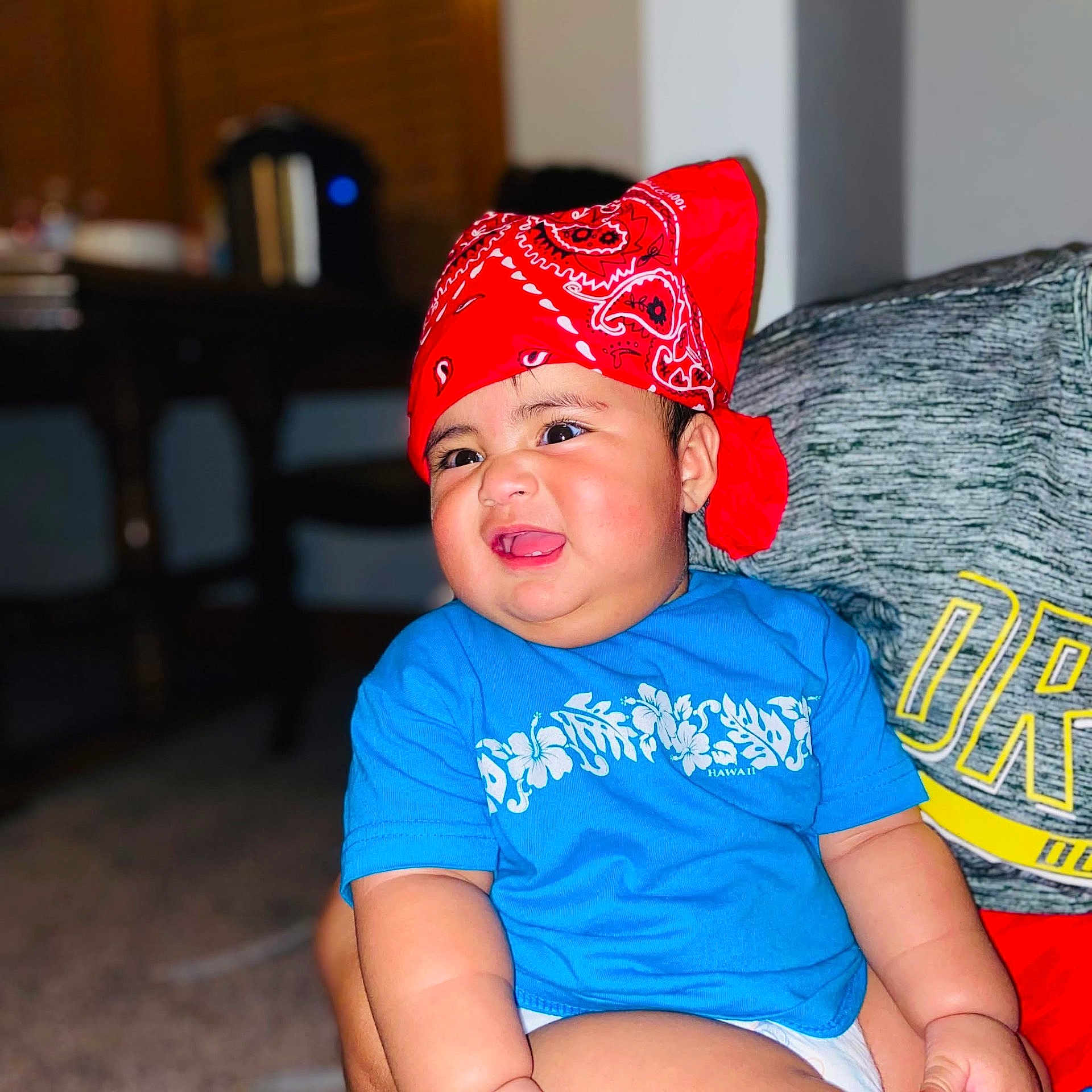 Jesreen joined the competition — help win amazing prizes! baby, child, infant, portrait, smiling, tongue_out, bandana, red_headwear, blue_shirt, floral_pattern, sitting, armchair, indoor, home, face, eyes, cheeks, happy, casual_clothing, photography