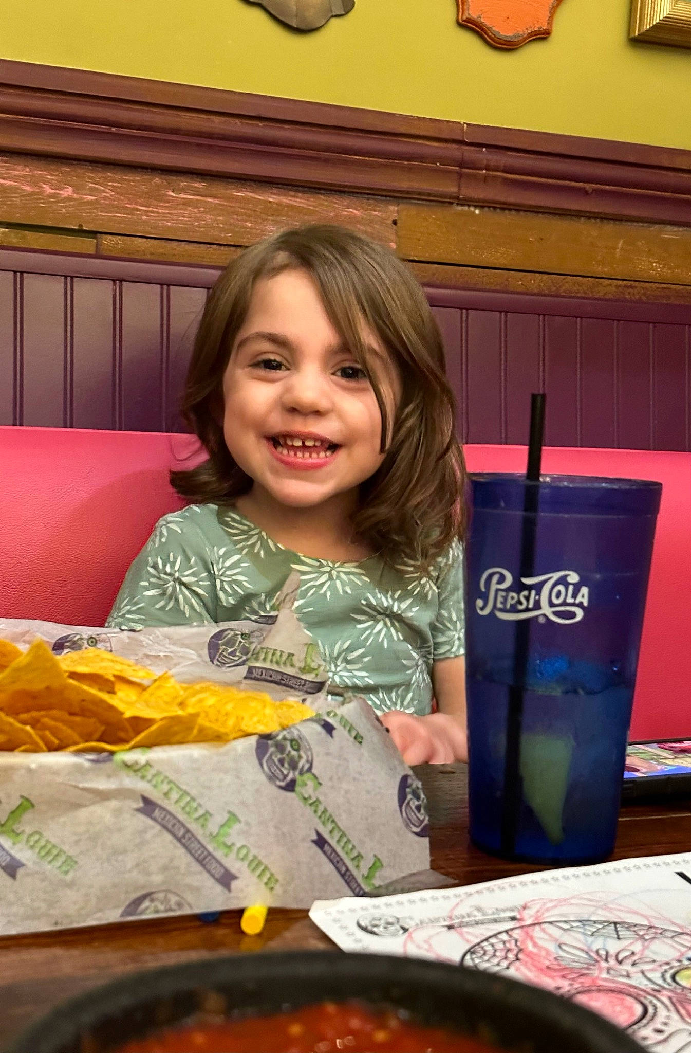 Lyla is registered to the contest to win money with this photo: child, comfort_food, cuisine, dish, event, food, fun, happy, joy, junk_food, meal, person, plate, recipe, room, smile, t_shirt, table, tableware, toddler